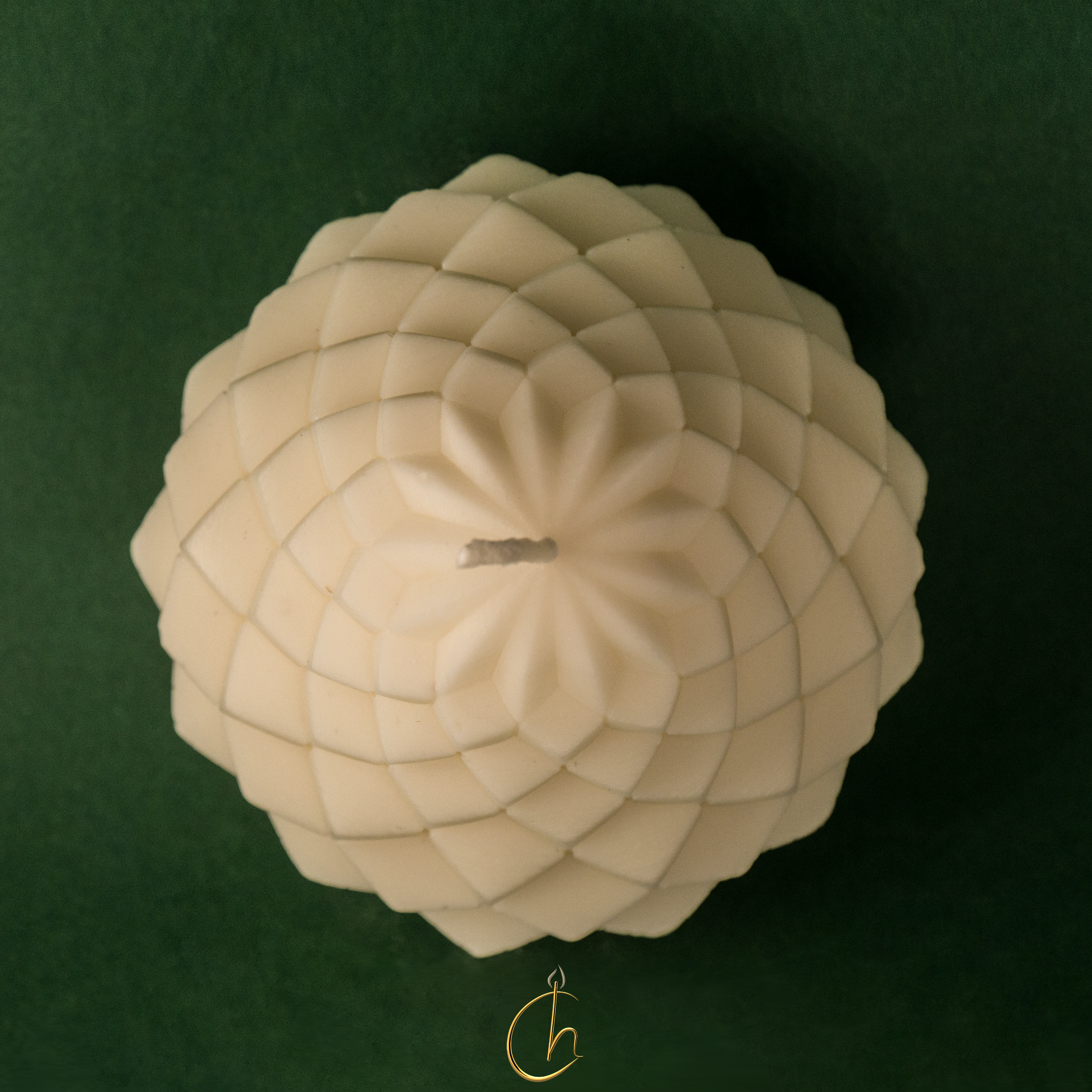 Chillness lotus sphere candle — top view on green velvet